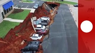 Drone footage Giant sinkhole swallows 14 cars in Mississippi parking lot [upl. by Ahsirahc436]