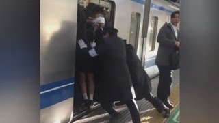 Professional Pushers Shove Passengers Onto Busy Tokyo Train [upl. by Ennoid730]